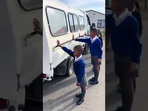 SCHOOLCHILDREN PAUSE IN PRAYER BEFORE BOARDING SCHOOL TRANSPORT