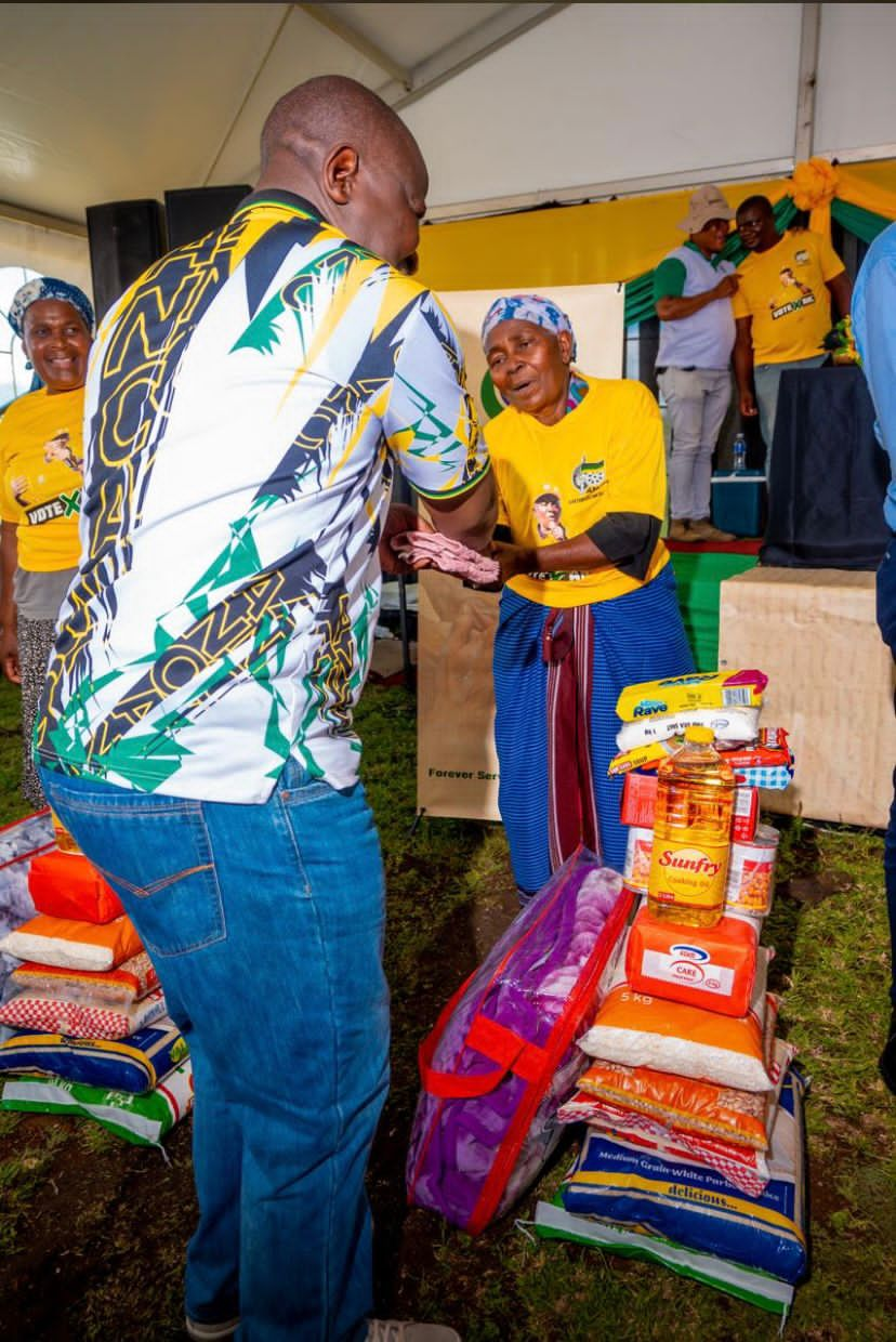 Elderly women holding food parcels during a festive season relief drive in Jozini, KwaZulu-Natal