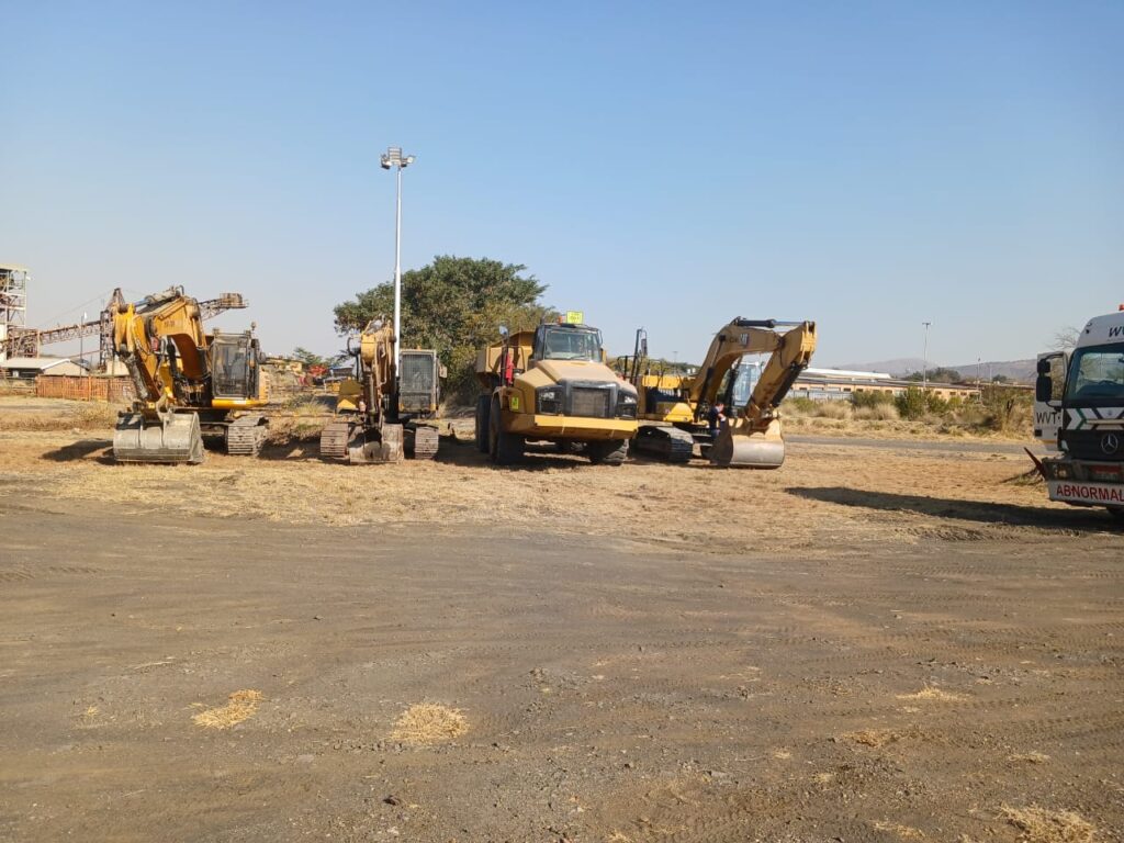 four (4) excavators and one (1) dump truck